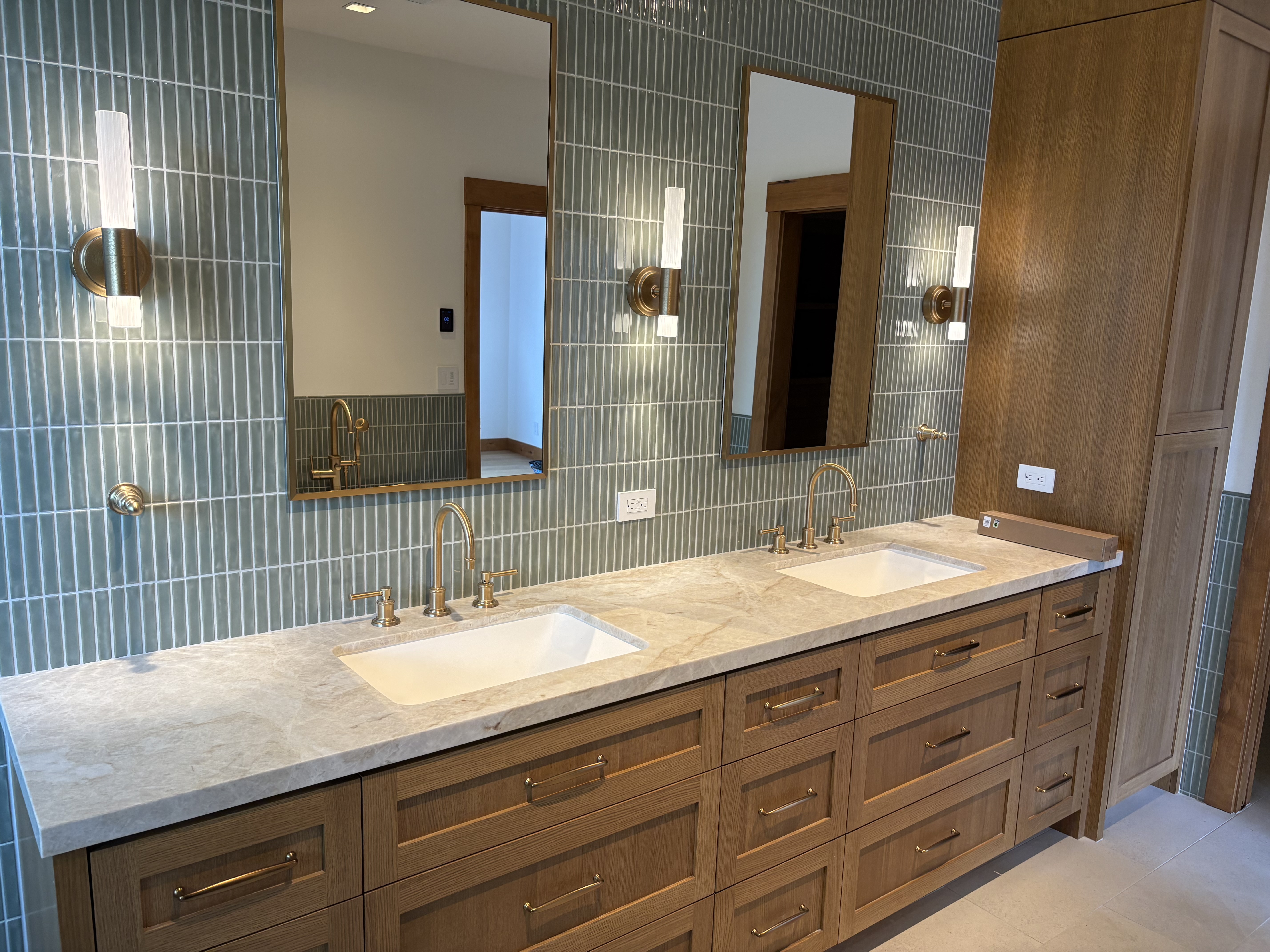 Double vanity in green tile bathroom